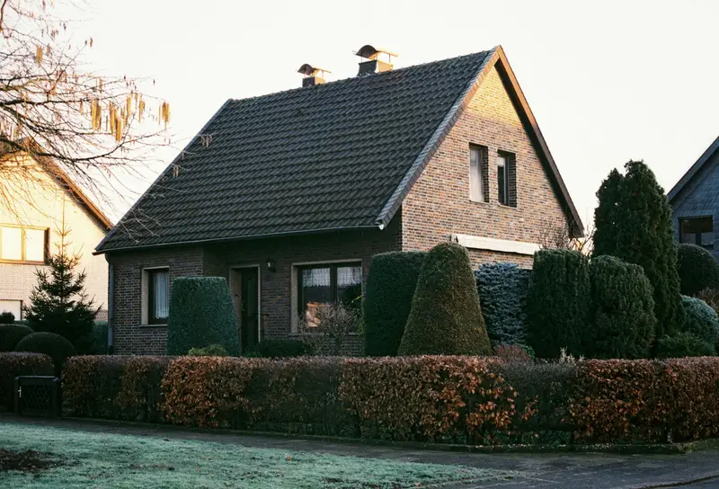 Einfamilienhaus aus den Sechzigerjahren mit neu eingedecktem dunklem Ziegeldach